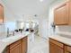 Bright, open floorplan view from kitchen to living space and staircase at 3730 82Nd Avenue E Cir # 104, Sarasota, FL 34243