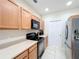 Well-lit kitchen features stainless steel refrigerator, black oven, and light countertops at 3730 82Nd Avenue E Cir # 104, Sarasota, FL 34243