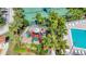 Aerial view of a colorful playground set, lush landscaping, and tennis courts in a well-maintained community at 3730 82Nd Avenue E Cir # 104, Sarasota, FL 34243