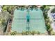 Aerial view of well-maintained tennis courts surrounded by lush landscaping and mature trees in a gated community at 3730 82Nd Avenue E Cir # 104, Sarasota, FL 34243