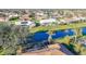 Aerial view of the neighborhood highlighting waterfront, pools, mature trees, and tile roofs at 389 Eden Dr, Englewood, FL 34223