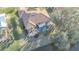 Aerial view of home highlighting screened-in pool, tile roof, landscaping, and water access at 389 Eden Dr, Englewood, FL 34223