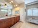 Bright bathroom featuring double sinks, granite countertops, decorative rug, and tiled floors at 389 Eden Dr, Englewood, FL 34223