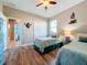 Cozy bedroom featuring wooden floors, twin beds, ceiling fan, and closet at 389 Eden Dr, Englewood, FL 34223