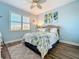 Cozy bedroom with stylish bedding, a light blue wall, and window at 389 Eden Dr, Englewood, FL 34223