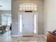 Clean, bright entrance featuring white door with sidelights and transom window at 389 Eden Dr, Englewood, FL 34223