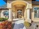 Welcoming front entrance with a decorative door, arched entryway, and manicured landscaping at 389 Eden Dr, Englewood, FL 34223