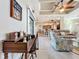 Open-concept living space with tile flooring, a decorative ceiling fan, and a view into the kitchen at 389 Eden Dr, Englewood, FL 34223