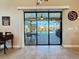 Sliding glass doors opening to a screened lanai with a pool and outdoor seating area at 389 Eden Dr, Englewood, FL 34223