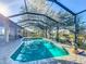 Beautiful screened pool with lush landscaping and scenic views, perfect for relaxation at 389 Eden Dr, Englewood, FL 34223