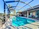 Screened-in pool with brick patio and tranquil views, perfect for relaxation and outdoor enjoyment at 389 Eden Dr, Englewood, FL 34223