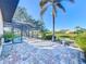 Back patio with water views overlooks screened-in pool at 389 Eden Dr, Englewood, FL 34223