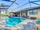 Private screened-in pool with stylish patio, barbecue area, and sunny views, a perfect retreat at 389 Eden Dr, Englewood, FL 34223