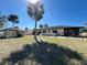 Expansive backyard featuring a shed, angel statue, palm trees, patio, and green lawn at 4052 Holin Ln, North Port, FL 34287