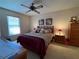 Cozy bedroom with a ceiling fan, window, and a queen-sized bed with lamps at 4052 Holin Ln, North Port, FL 34287