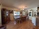 Traditional dining room with wood floors, chandelier, and glass display cabinets at 4052 Holin Ln, North Port, FL 34287