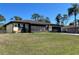 Charming single story home with a well maintained lawn, two car garage, and a front screened in porch at 4052 Holin Ln, North Port, FL 34287