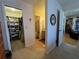 Hallway featuring a walk-in closet, a bathroom, and entry into another room at 4052 Holin Ln, North Port, FL 34287