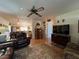 Comfortable living room with hardwood floors, a ceiling fan, and an open layout at 4052 Holin Ln, North Port, FL 34287