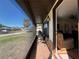 View of the covered and screened in porch with tile flooring and an outdoor seating area at 4052 Holin Ln, North Port, FL 34287