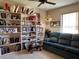 Sitting room features a sofa, bookshelves, and a ceiling fan at 4052 Holin Ln, North Port, FL 34287