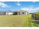 Large backyard with grassy lawn and screened patio at 4309 Renwick Dr, Parrish, FL 34219