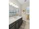 Elegant bathroom with dark vanity, quartz countertop, and a shower at 4309 Renwick Dr, Parrish, FL 34219