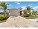 Tan house with palm trees and a paved driveway at 4309 Renwick Dr, Parrish, FL 34219