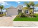 Single-story home with a two-car garage and landscaped front yard at 4309 Renwick Dr, Parrish, FL 34219