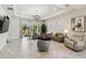 Living room with gray sofas, large windows, and sliding glass doors at 4309 Renwick Dr, Parrish, FL 34219