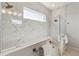 Large walk-in shower with marble tile and a window at 4309 Renwick Dr, Parrish, FL 34219