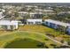 Beautiful aerial view of the condo complex with golf course and mature trees at 435 Cerromar Ln # 328, Venice, FL 34293