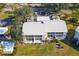 Aerial shot showcasing the condo complex, mature trees and covered parking at 435 Cerromar Ln # 328, Venice, FL 34293