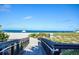 Beach boardwalk leading to a sandy shore with clear water views and a tranquil atmosphere for enjoying the beach at 435 Cerromar Ln # 328, Venice, FL 34293