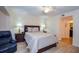 Comfortable bedroom with a king-size bed and two bedside lamps on nightstands at 435 Cerromar Ln # 328, Venice, FL 34293