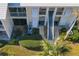 Exterior shot of the condo complex featuring palm trees and landscaping at 435 Cerromar Ln # 328, Venice, FL 34293