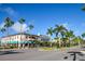 Charming street view with lush palm trees and shops with awnings under a beautiful blue sky at 435 Cerromar Ln # 328, Venice, FL 34293