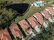 Aerial view of a community with pool, pond and beautiful landscaping at 4951 Summertree Rd, Venice, FL 34293