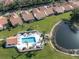 Community pool featuring lounge chairs and palm trees on a bright sunny day at 4951 Summertree Rd, Venice, FL 34293