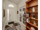 Bright foyer with French doors, decorative rug and a custom wooden bookshelf at 4951 Summertree Rd, Venice, FL 34293