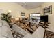 Inviting living room with comfortable seating, a ceiling fan, and views of the lanai at 4951 Summertree Rd, Venice, FL 34293