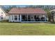 Exterior view of a home with a screen enclosed porch and a well-maintained lawn at 4951 Summertree Rd, Venice, FL 34293