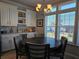 Bright dining area featuring white cabinetry and decorative accents near a window at 530 Walnut Cir, Venice, FL 34285