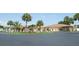 Low maintenance community building with palm tree landscaping on expansive grounds at 530 Walnut Cir, Venice, FL 34285