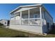 Inviting front porch with ceiling fans offers a relaxing outdoor space, perfect for entertaining at 530 Walnut Cir, Venice, FL 34285