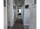 Hallway view leading into the bedroom with carpet and vinyl flooring at 530 Walnut Cir, Venice, FL 34285