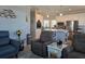 Cozy living room with a view of the eat-in kitchen with stainless steel appliances and white cabinetry at 530 Walnut Cir, Venice, FL 34285