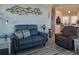 Cozy living room with modern furniture and decor next to an eat-in kitchen with stainless steel appliances at 530 Walnut Cir, Venice, FL 34285