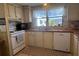 Cozy kitchen featuring white cabinets, appliances, and lots of counter space at 5311 Palena Blvd, North Port, FL 34287