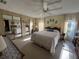 Bright main bedroom featuring a ceiling fan, mirrored closet, and sunny windows at 5311 Palena Blvd, North Port, FL 34287